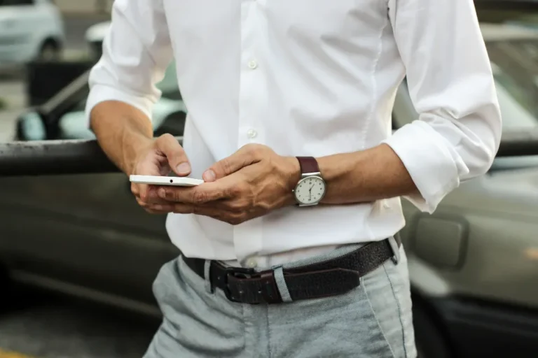 A businessman in a white shirt using his smartphone